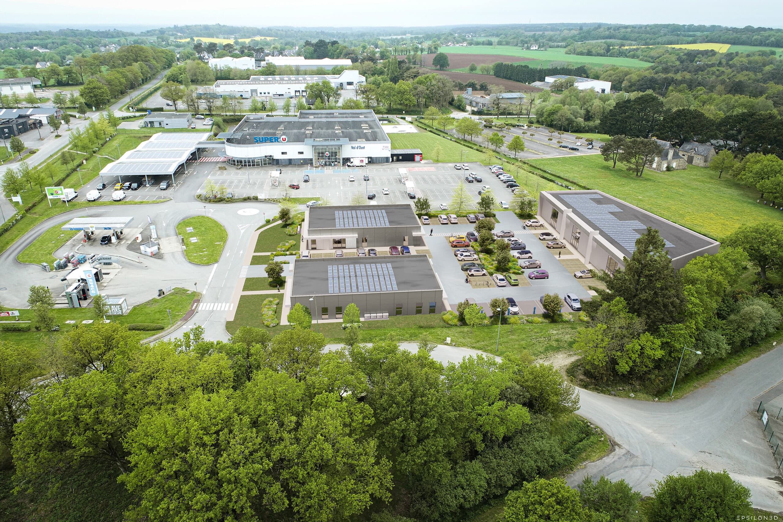 Vue aérienne de la zone commerciale de Malestroit avec le Super U, des bâtiments équipés de panneaux solaires et leurs parkings